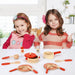 Two children with a 14-piece wooden cooking set, toy pots, pans, utensils on a table