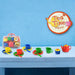 Colorful kids tea set with cups, teapot, spoons, and carry case on blue table