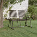 Black metal 2-seater garden bench with side tables on green lawn under tree