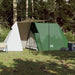 Three-person green A-frame camping tent with dual protection set up on grass in a forest