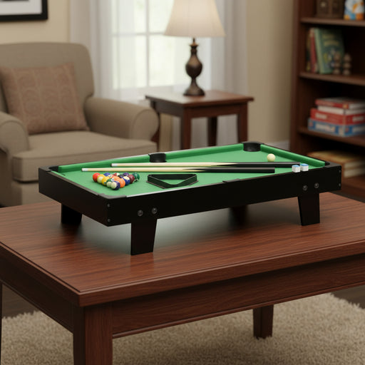 3ft black portable tabletop pool table on a wooden coffee table in a cozy living room