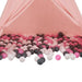 Pink tent filled with white, grey, and pink baby play balls on the floor
