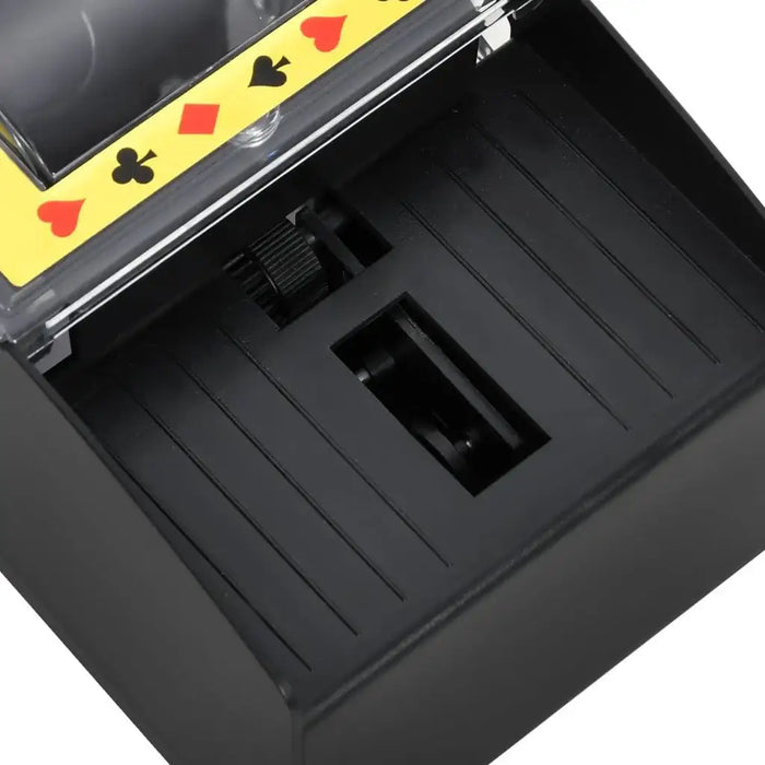 Automatic card shuffler with black base, club, heart, diamond, and spade symbols on yellow edge