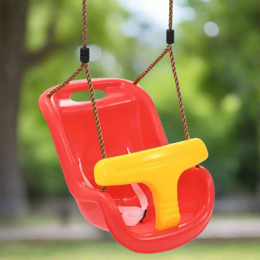 Red and yellow baby safety swing with bar and belt, hanging outdoors