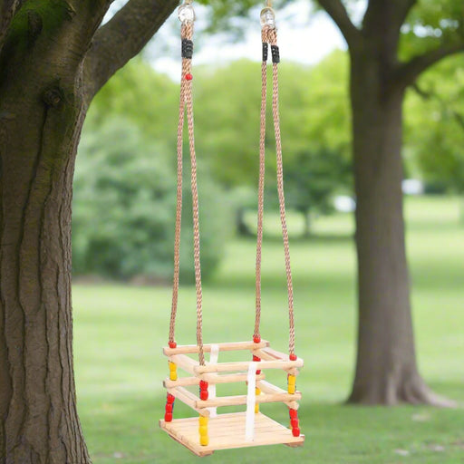 Solid pinewood baby swing with red and yellow beads hanging from a tree in a park