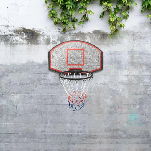 Wall-mounted basketball backboard set with steel rim and net on concrete wall, outdoor setting