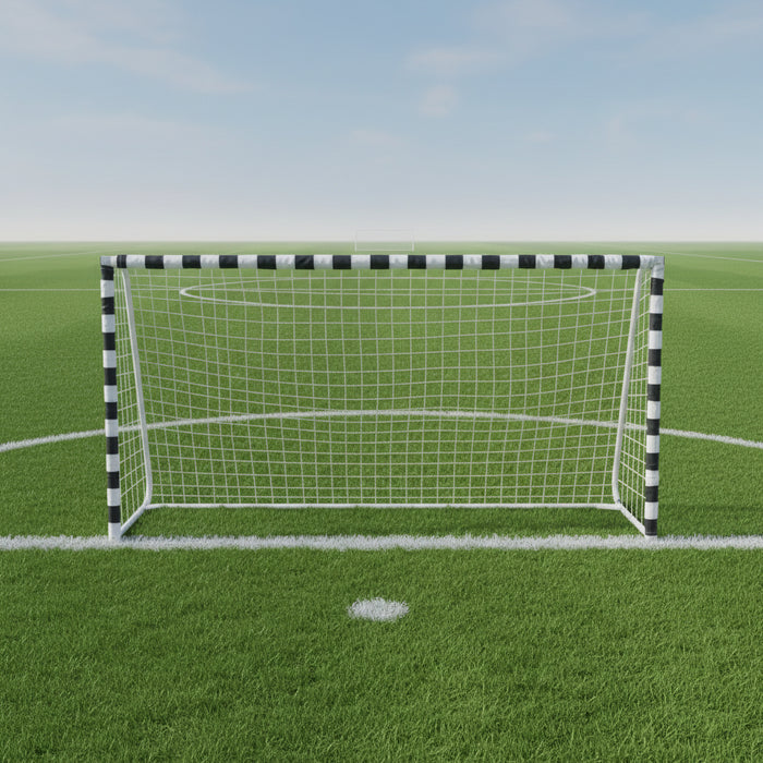 Black and white football goal with metal frame on green soccer field under blue sky