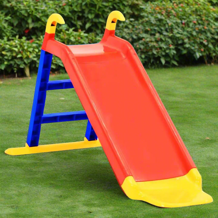 Colorful plastic kids slide for indoor and outdoor play on green grass lawn