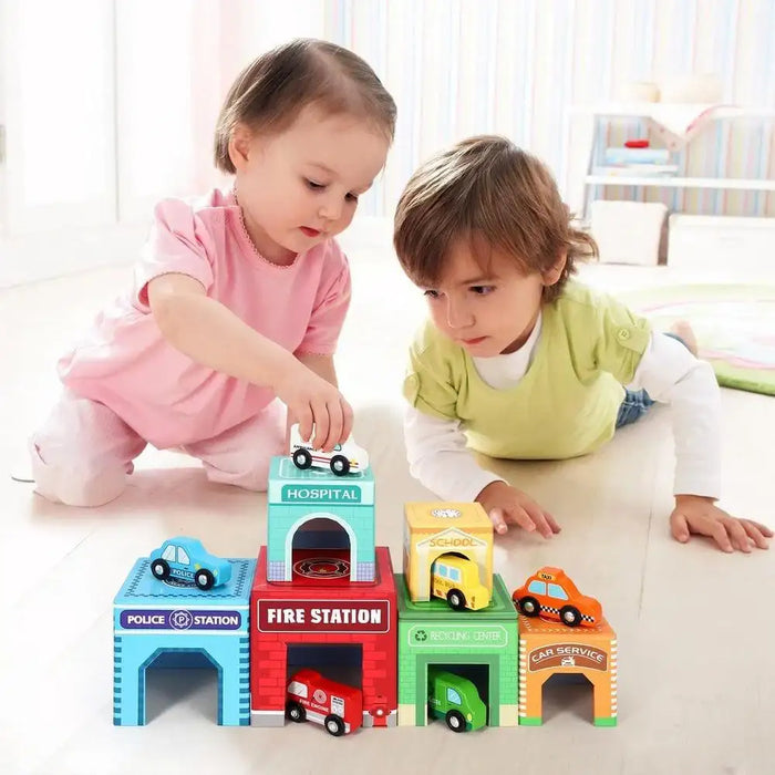 Toddlers playing with emergency vehicle stacking cubes and toy cars on the floor.