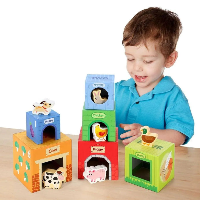 Child playing with colorful farm animal stacking cubes, featuring numbers and animals