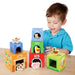 Child playing with colorful farm animal stacking cubes, featuring numbers and animals