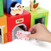 Hand placing pig block in colorful farm animal stacking cubes toy with dog and duck pieces