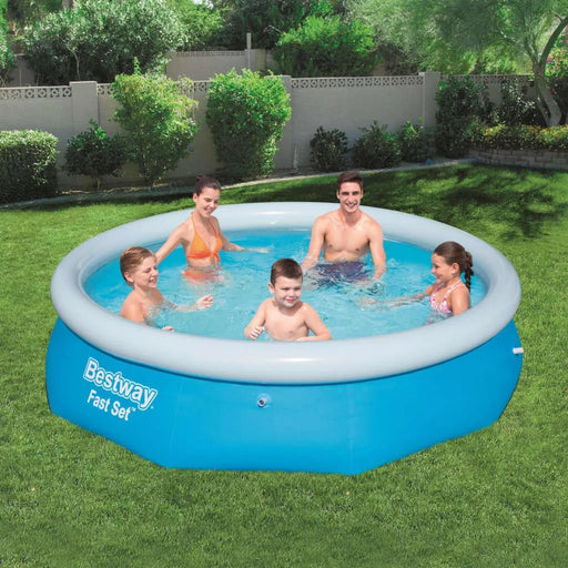 Family enjoying Bestway Fast Set inflatable pool in backyard on green grass