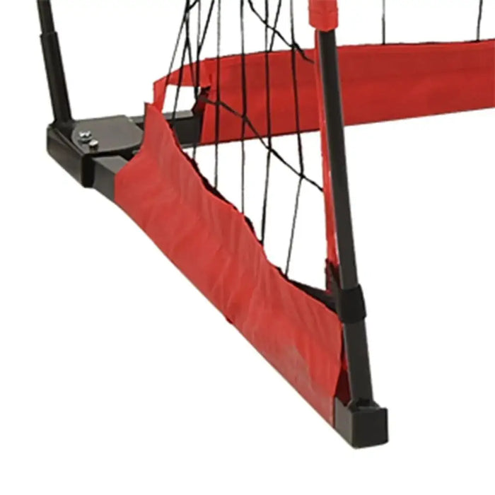 Corner of a foldable portable football goal with red polyester net and black steel frame