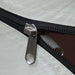 Close-up of a green taffeta tent zipper with black trim for storage or camping