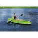 Woman paddling Hydro-Force inflatable kayak on calm lake, wearing life vest