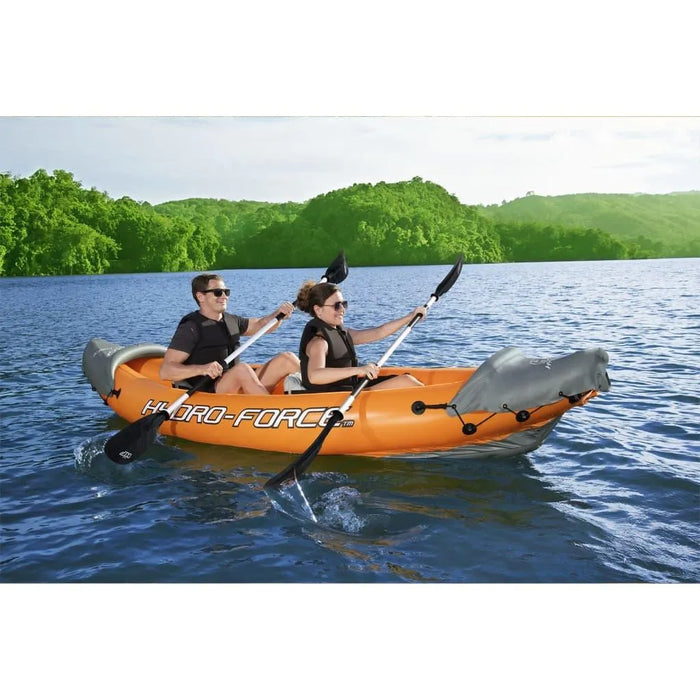 Two people kayaking in an orange Hydro-Force inflatable kayak on a lake