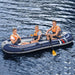 Three people wearing life jackets in a blue Hydro-Force Treck X3 inflatable boat on water