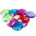 Colorful translucent plastic gems in green, blue, red, and purple on a white background