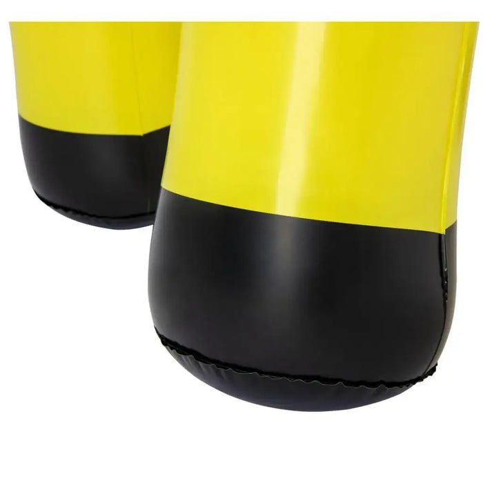 Close-up of yellow and black inflatable giraffe sprinkler legs, outdoor water toy