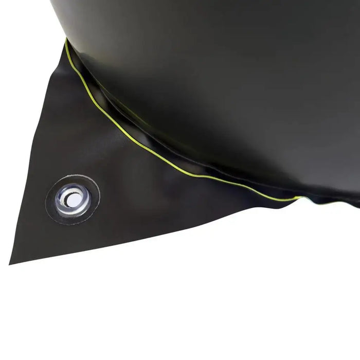 Close-up of black inflatable material with metal grommet, part of outdoor water toy.