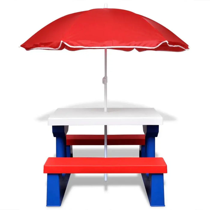 Kids picnic table with red and blue benches, white tabletop, and a large red umbrella