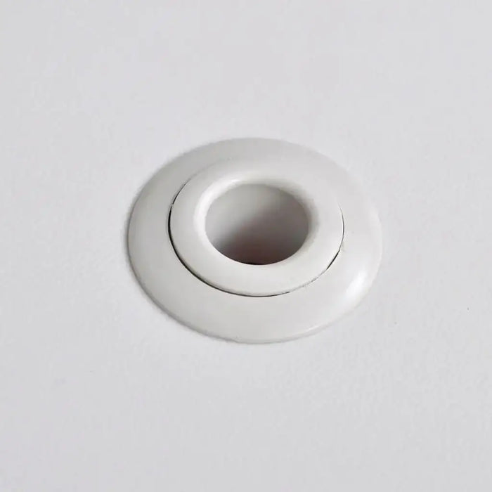 Close-up of a white plastic umbrella hole on a kids picnic table surface