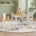 Kids table and chair set in white and beige with wooden blocks in playroom setting