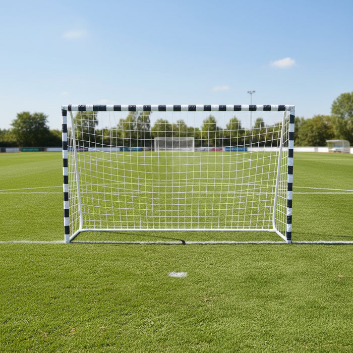 Large metal football goal with weather-resistant net on green soccer field