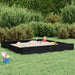 Large black wooden sandbox with sand toys on green lawn, bushes in background