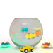 Magic doodle cars with LED lights racing inside and around a clear glass bowl on white background
