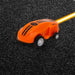 Orange magic doodle car toy with LED lights on black textured surface