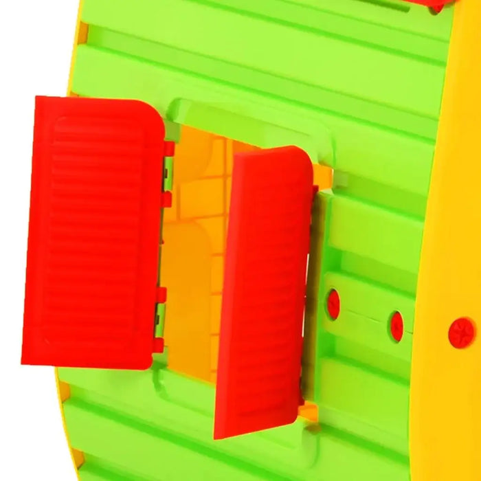 Close-up of multicolour kids playhouse with bright red window shutters and green walls