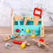 Colorful wooden toy tool box set with hammer, saw, nuts, and bolts on a wood surface