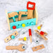 Wooden toy toolbox set with hammer, wrench, saw, ruler, bolts and nuts on marble surface