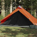 Orange taffeta one-person camping tent set up on grass in a wooded outdoor area