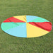 Round rainbow play parachute with colorful panels on grass, outdoor group activity game