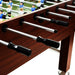 Professional brown wood football table with metal rods, black handles, and player figures