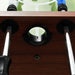 Close-up of brown finish professional foosball table with steel rods and ball return hole.