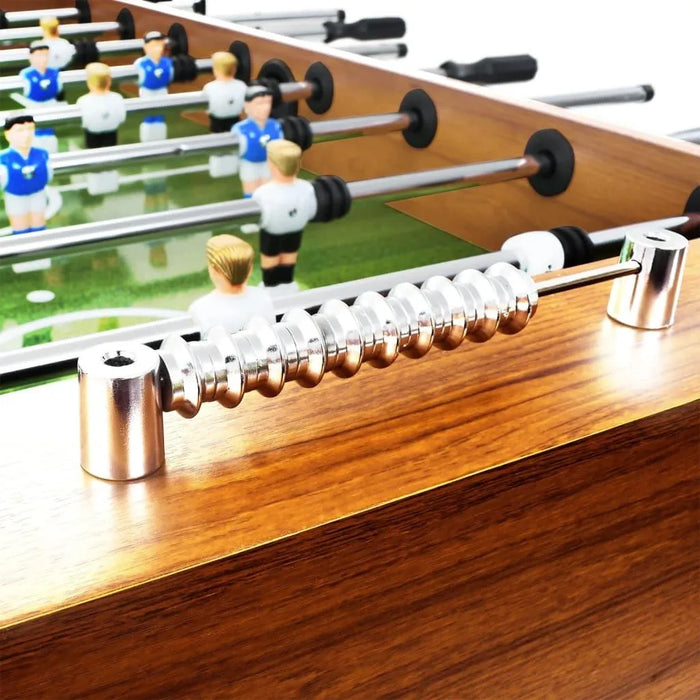 Professional football table with light brown wood finish, metal score counter, and player figures