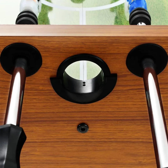 Professional football table with light brown wood finish and chrome rods, close-up view