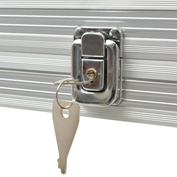 Close-up of silver lock with key on aluminum poker chip case