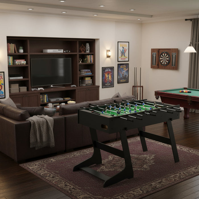Black professional tournament football table in modern family game room with pool table