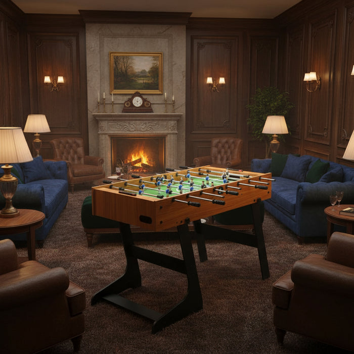 Professional tournament football table in elegant games room with fireplace and sofas