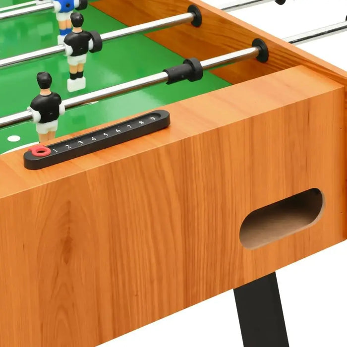 Wood finish professional foosball table with black score tracker and green field