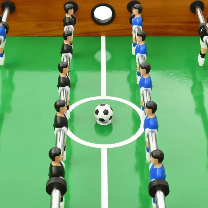 Professional tournament football table with foosball players and soccer ball on green field