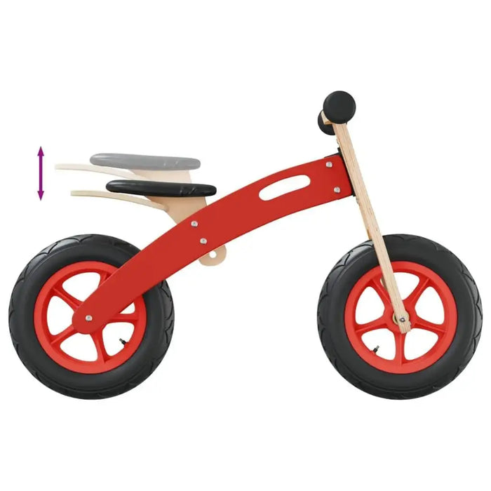 Red children's balance bike with adjustable seat, large black wheels, and wooden frame