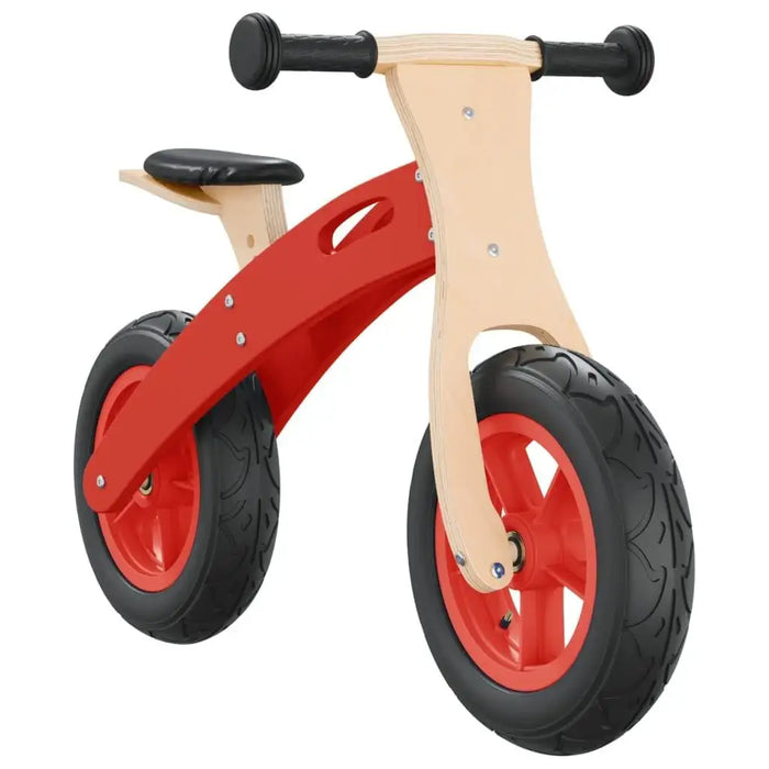 Red wooden balance bike with black seat and handlebar, chunky black tires
