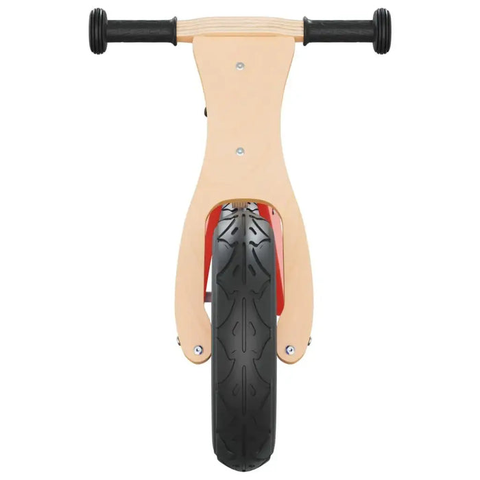 Front view of a wooden balance bike with black rubber handles and a large black tire