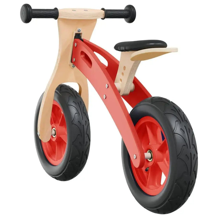 Red wooden balance bike with adjustable seat and handlebar, black tires, isolated view